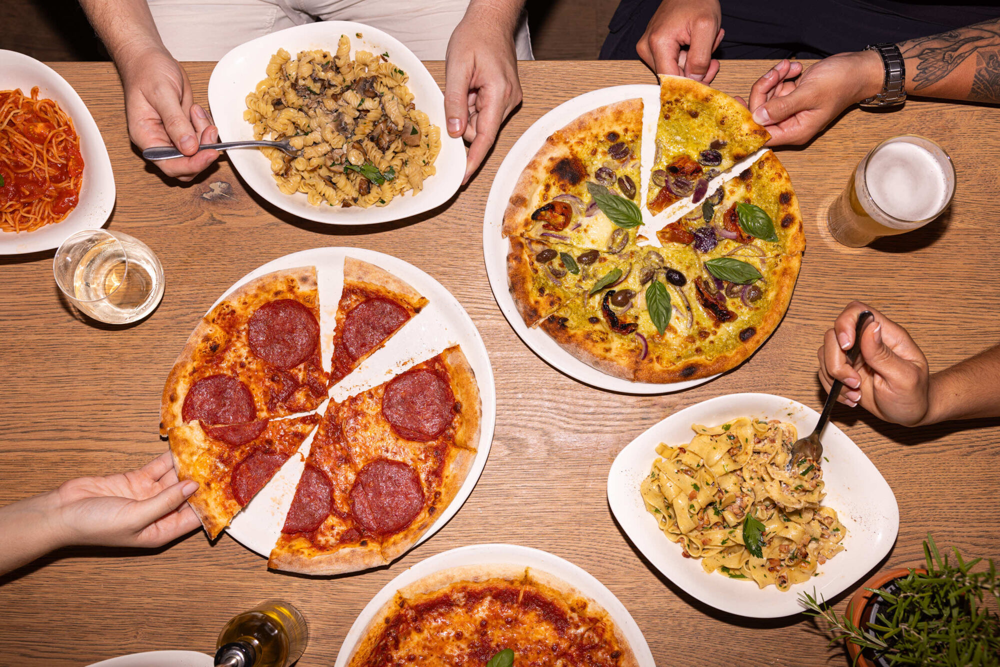 People eating pizza and pasta